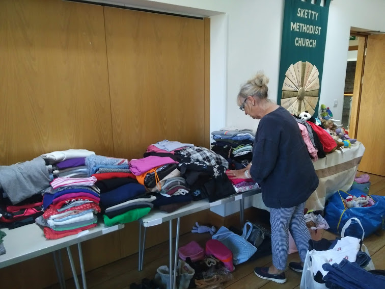 UiD trustee at the clothing bank